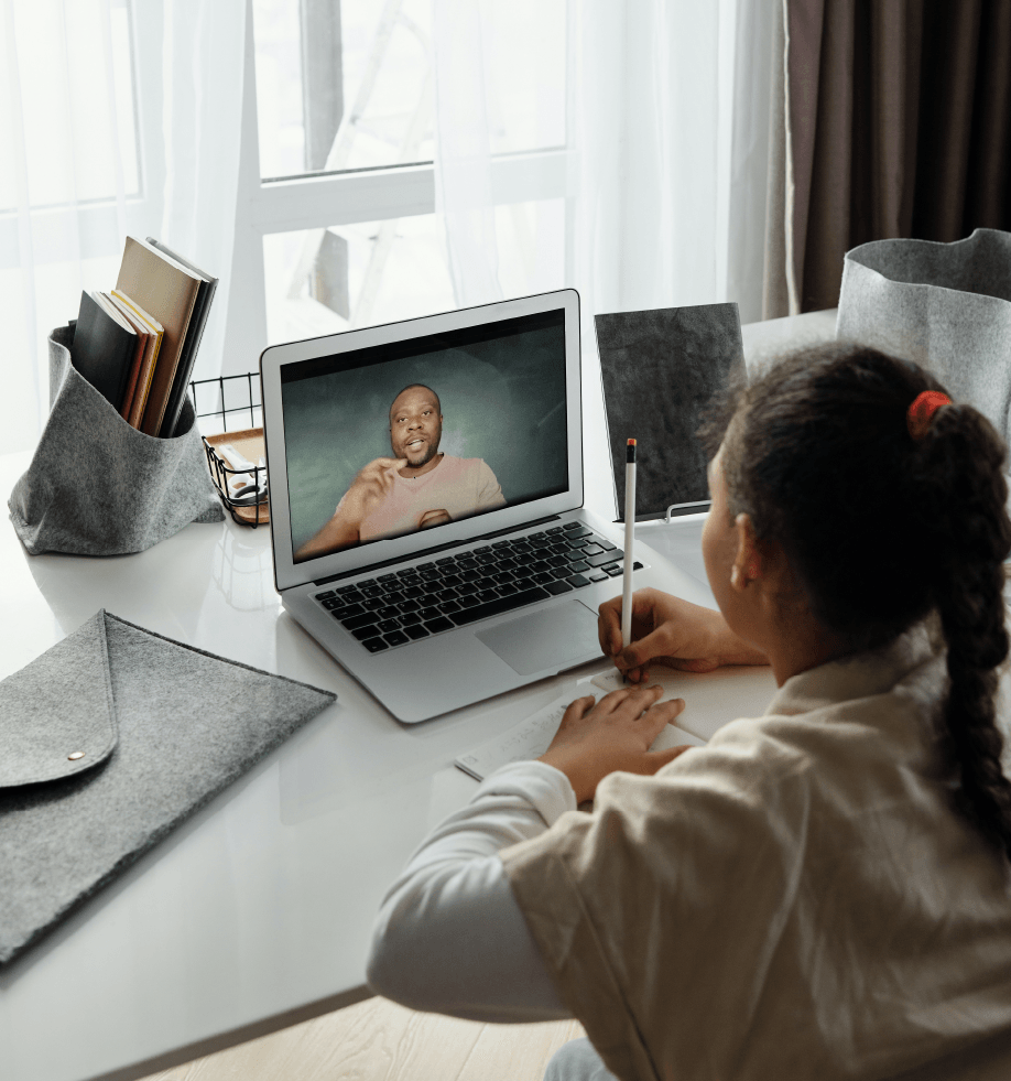 Young female student learning remotely on a laptop