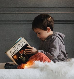 Young boy reading a book