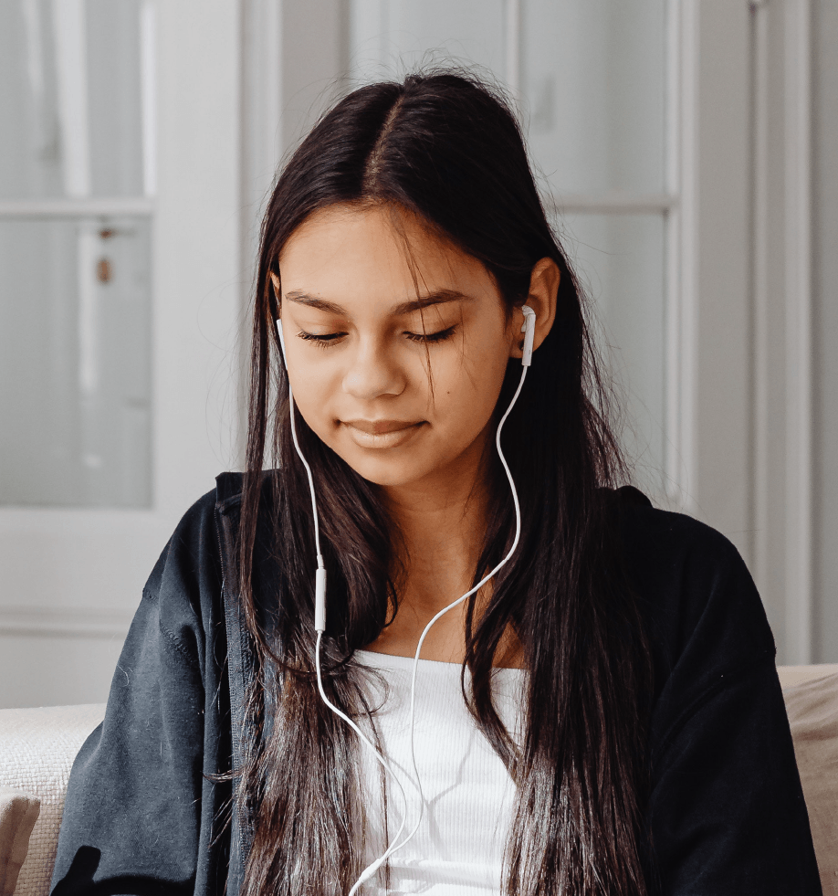 Female teenager smiling with headphones in
