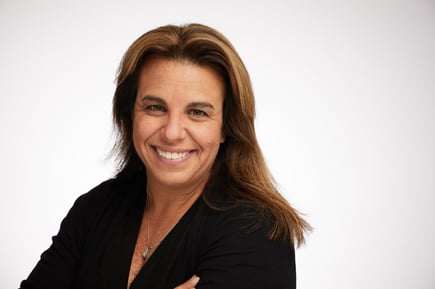 Photo description: Headshot of Jamie Farrell wearing black against a white background