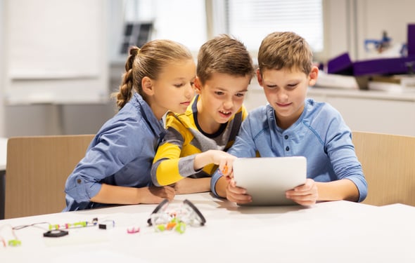 Students learning with tablets in class