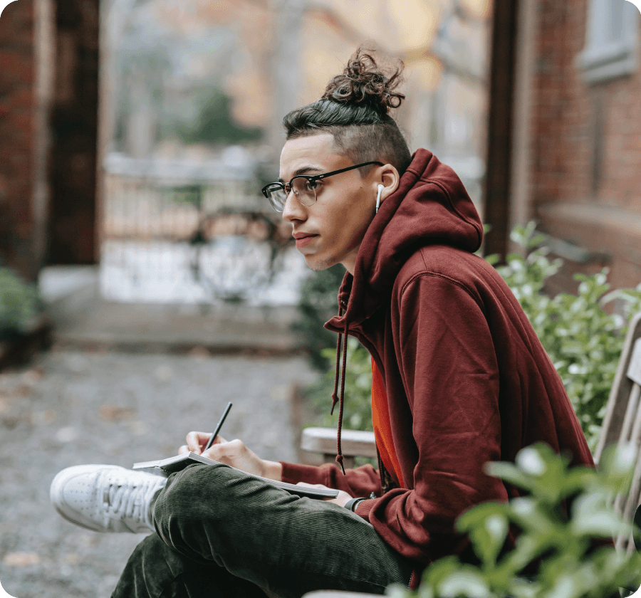 Male college student sitting on a bench